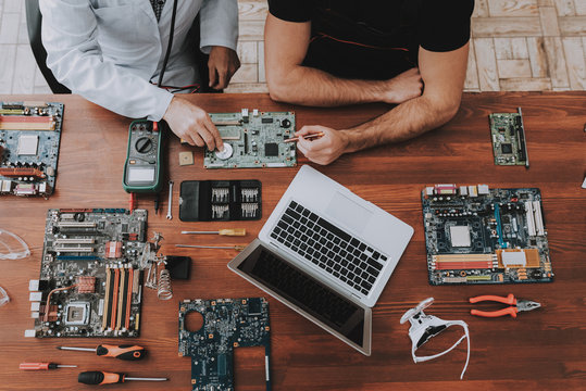 Computer technician repairing laptop hardware